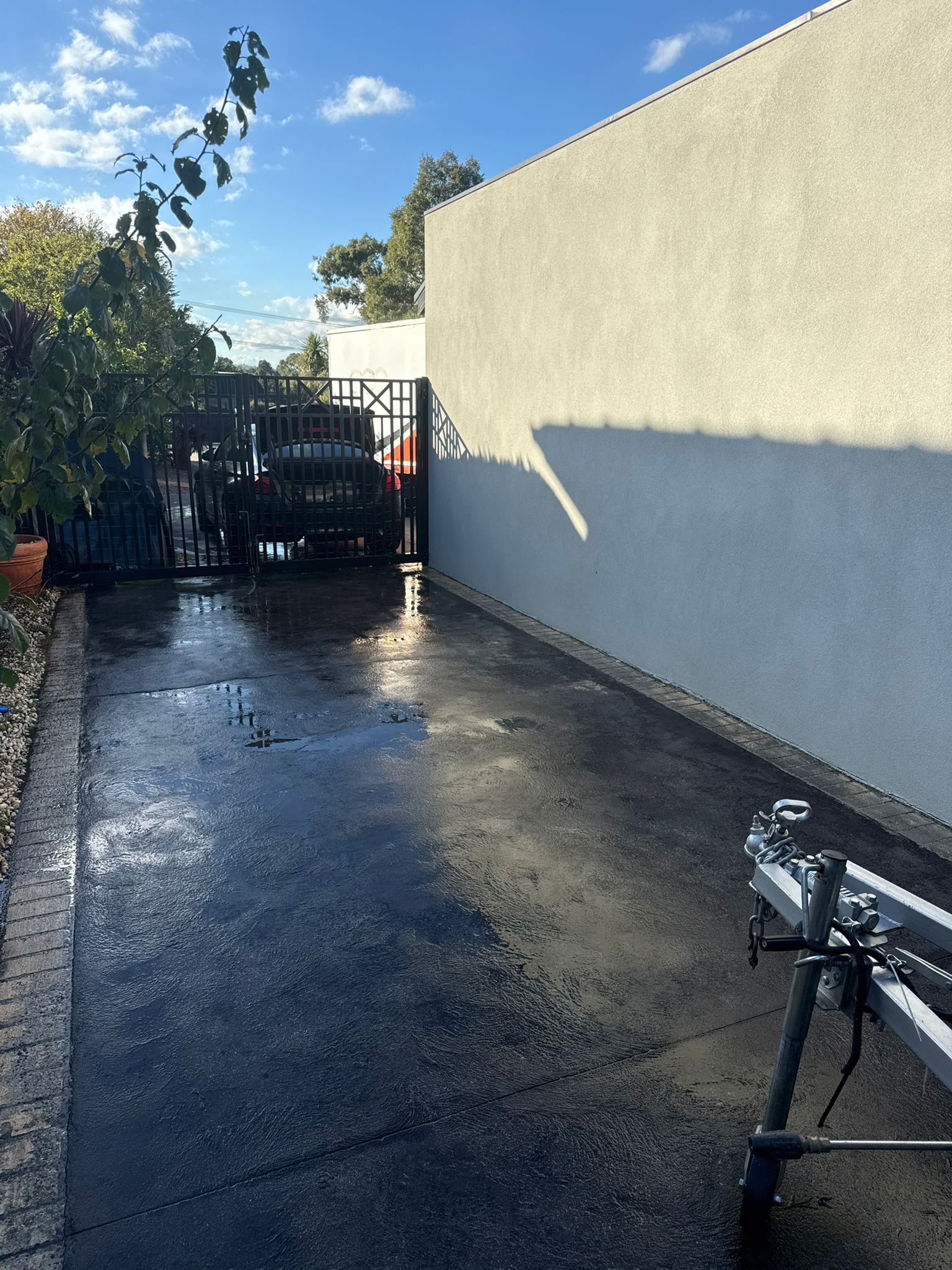 Driveway concrete after professional pressure washing Melbourne — clean restored surface