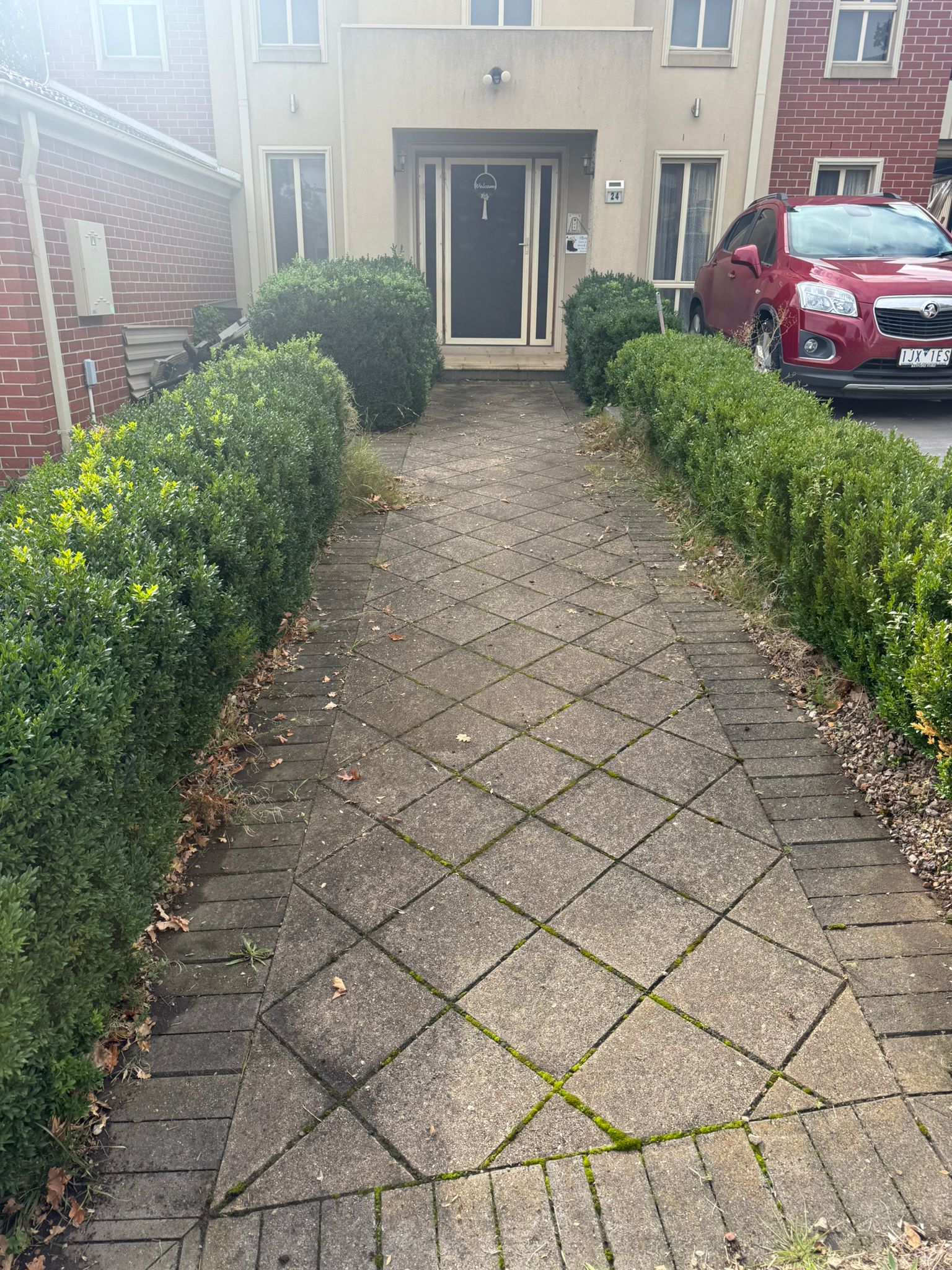 Outdoor paving before pressure washing — built-up grime and moss Melbourne